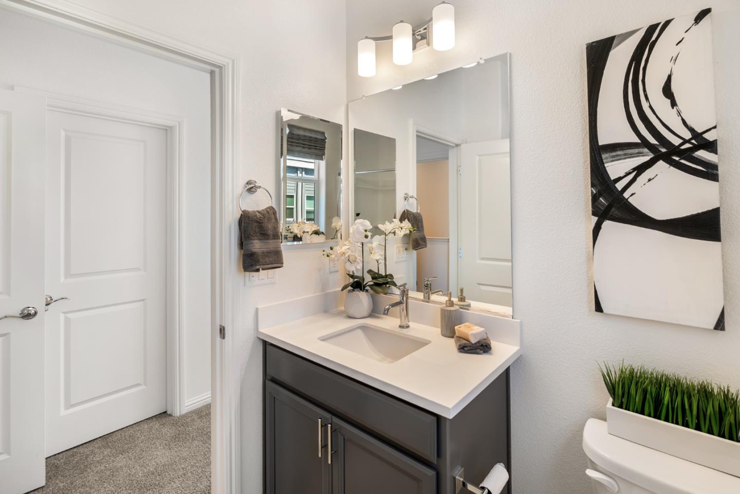 5724 Immersion Loop San Jose, CA 95119 - Photo 18 of 24 a bathroom with a sink a toilet and a mirror
