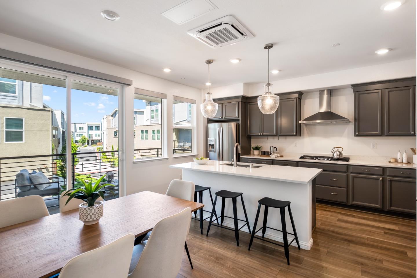 5724 Immersion Loop San Jose, CA 95119 - Photo 3 of 24 a large kitchen with a table and chairs in it