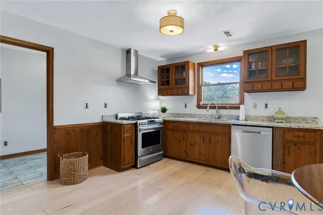 a kitchen with granite countertop a stove top oven sink and cabinets
