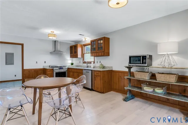 a kitchen with a table chairs sink and microwave