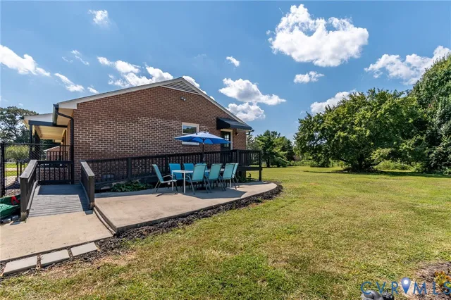 a view of a house with backyard porch and sitting area