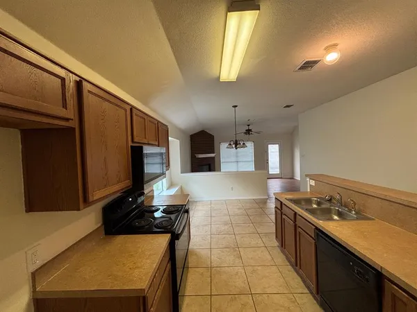 a kitchen with stainless steel appliances granite countertop a sink stove and cabinets