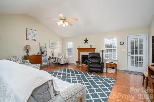 a living room with dining table and wooden floor