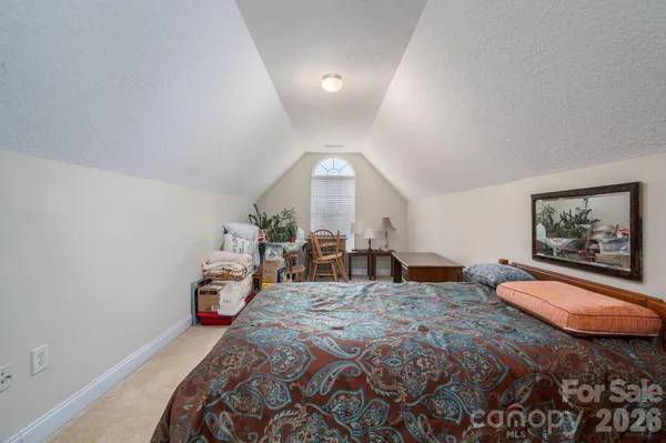 a bedroom with bed and wooden floor