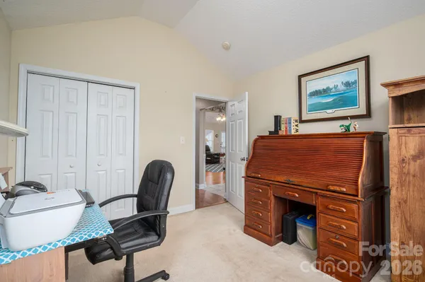 a living room with furniture and a mirror