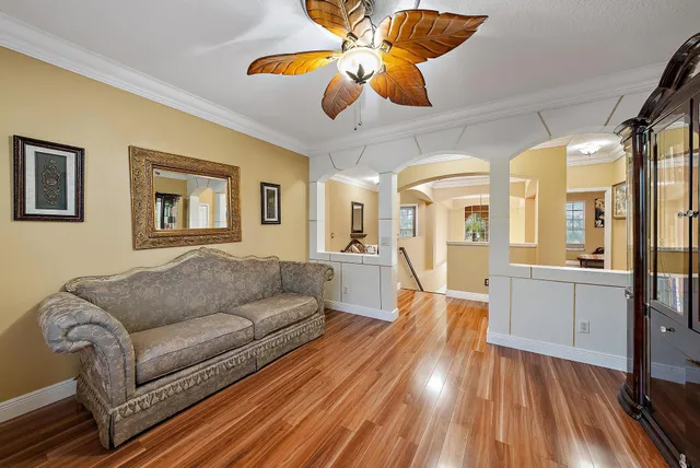 a living room with furniture and a chandelier