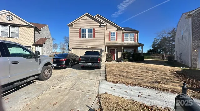 a view of a white house with large windows