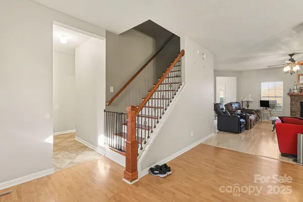 a view of a livingroom with furniture and stairs