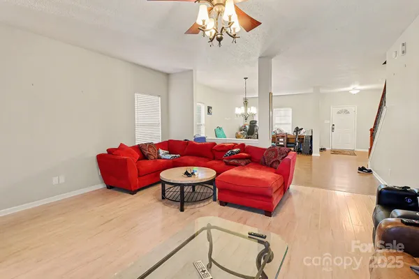a living room with furniture bathtub and a chandelier
