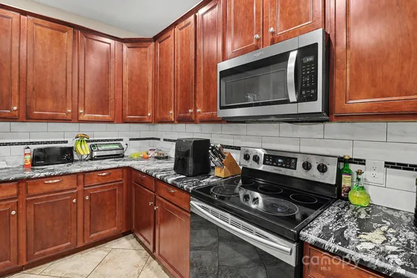 a kitchen with a stove and a microwave