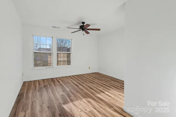 a view of a room with wooden floor and cabinet