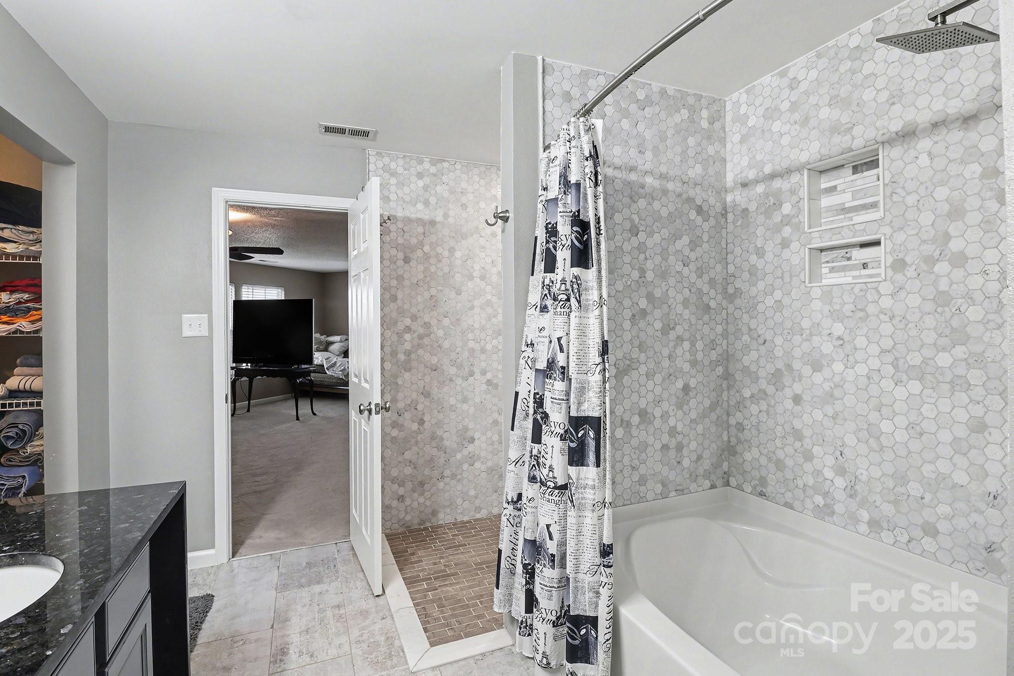 5307 Bendix Court Harrisburg, NC 28075 - Photo 5 of 25 a bathroom with a bathtub and a shower