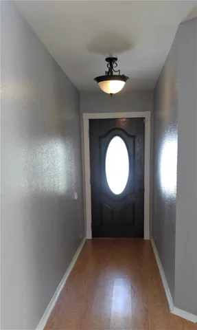 a view of a room with wooden floor and window