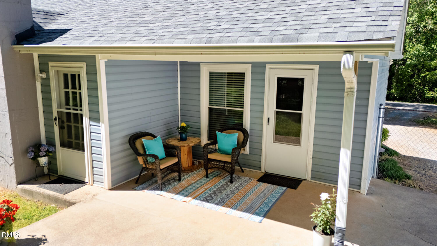 134 Longview Road Madison, NC 27025 - Photo 21 of 49 a view of a patio with table and chairs and floor to ceiling window and wooden fence