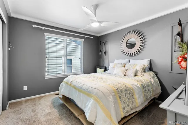 a bedroom with a bed and a large window