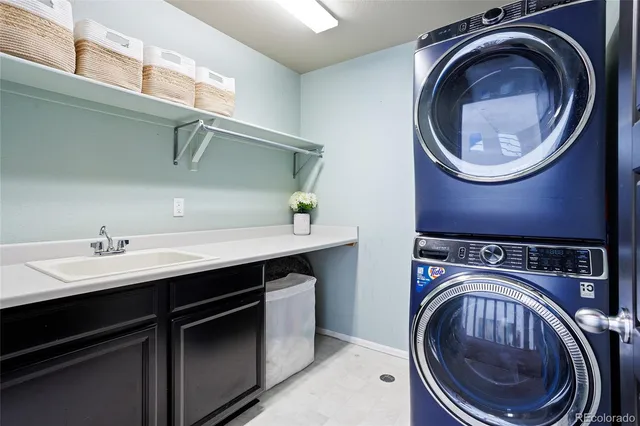 a utility room with sink dryer and washer