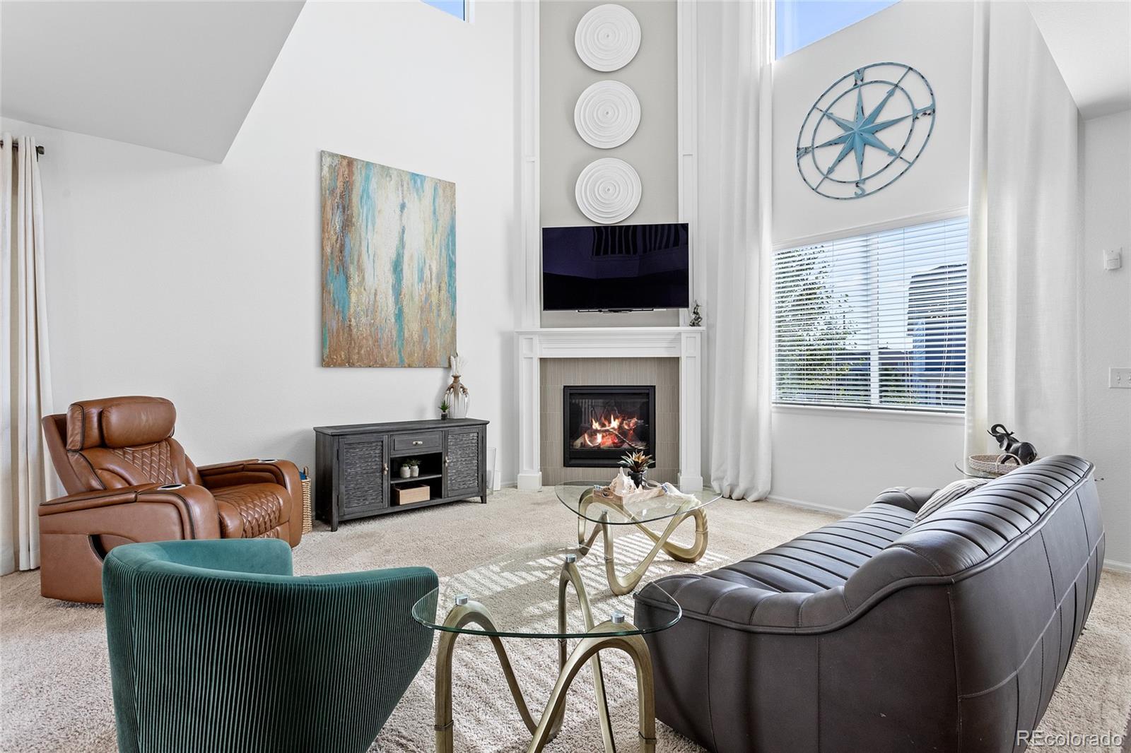 1444 Sidewinder Circle Castle Rock, CO 80108 - Photo 2 of 40 a living room with furniture a flat screen tv and a fireplace