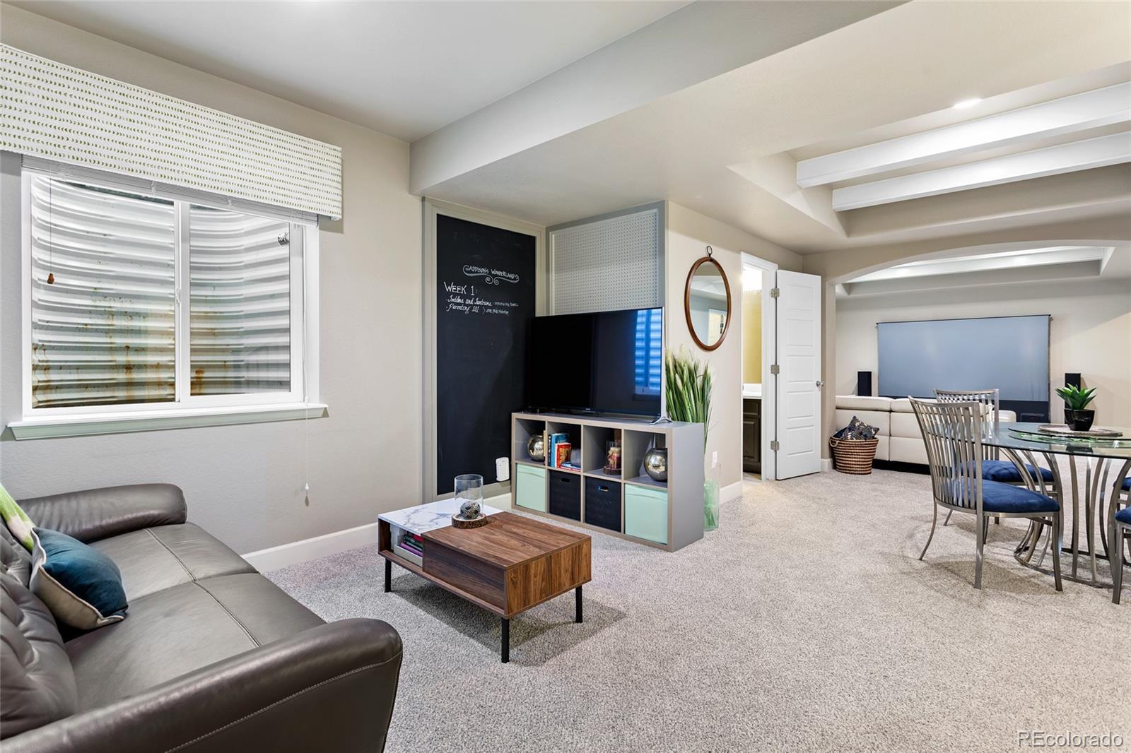 1444 Sidewinder Circle Castle Rock, CO 80108 - Photo 21 of 40 a living room with furniture and a flat screen tv