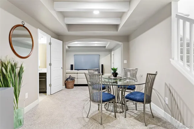 a dining room with furniture and a floor to ceiling window