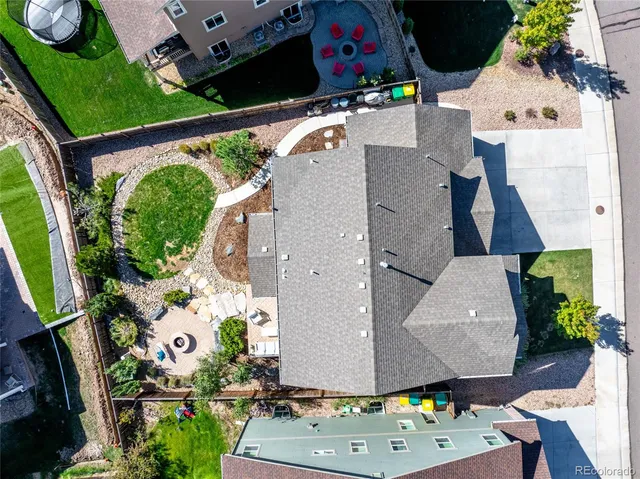 an aerial view of a house with a yard and a fountain