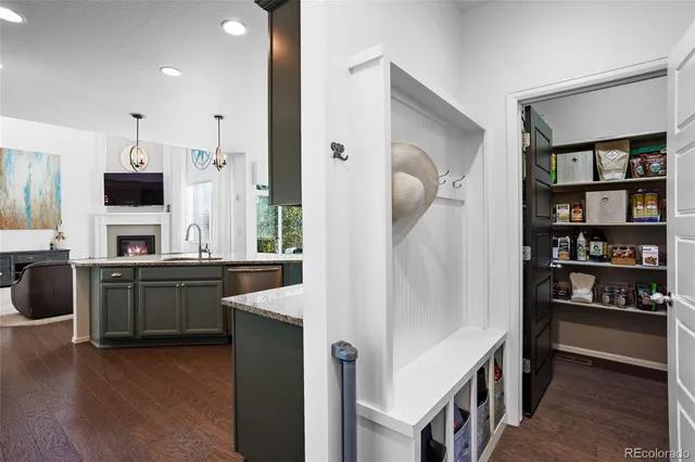 a kitchen with stainless steel appliances granite countertop a refrigerator a stove and a sink