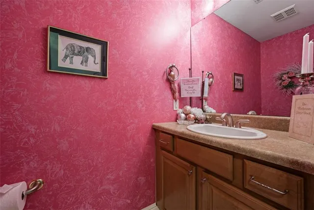 a bathroom with a sink and a mirror with painted walls