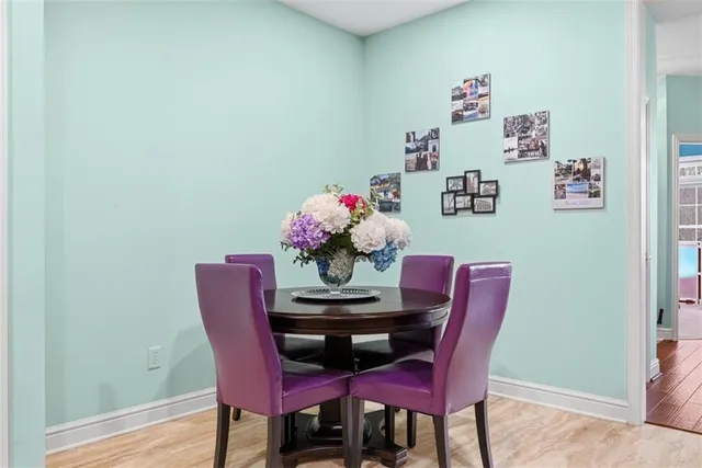 a dining room with furniture and wooden floor