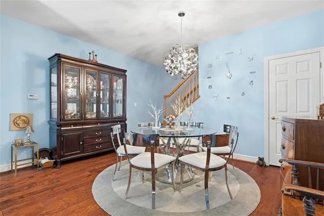 a dining room with furniture a chandelier and wooden floor