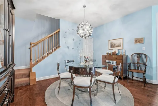 a dining room with furniture entryway and wooden floor