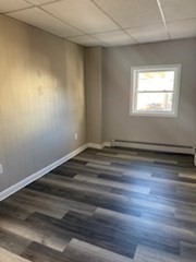 153 Union Street, Unit 1 Lawrence, MA 01841 - Photo 7 of 8 a view of a room with wooden floor and window