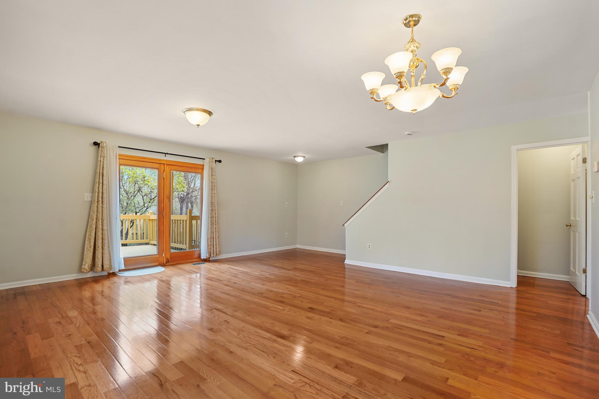 9412 Kilbride Court Perry Hall, MD 21128 - Photo 14 of 52 a view of an empty room with wooden floor and a window