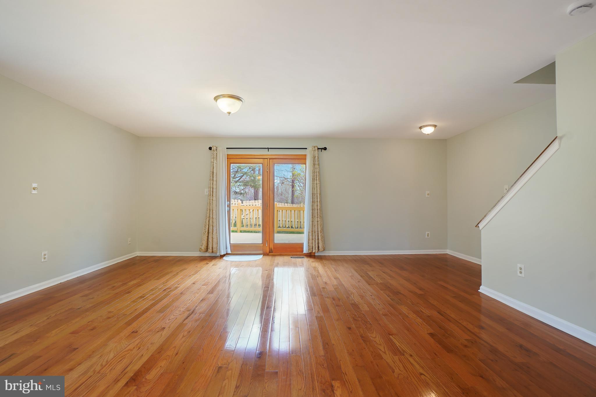 9412 Kilbride Court Perry Hall, MD 21128 - Photo 15 of 52 a view of an empty room with wooden floor and a window