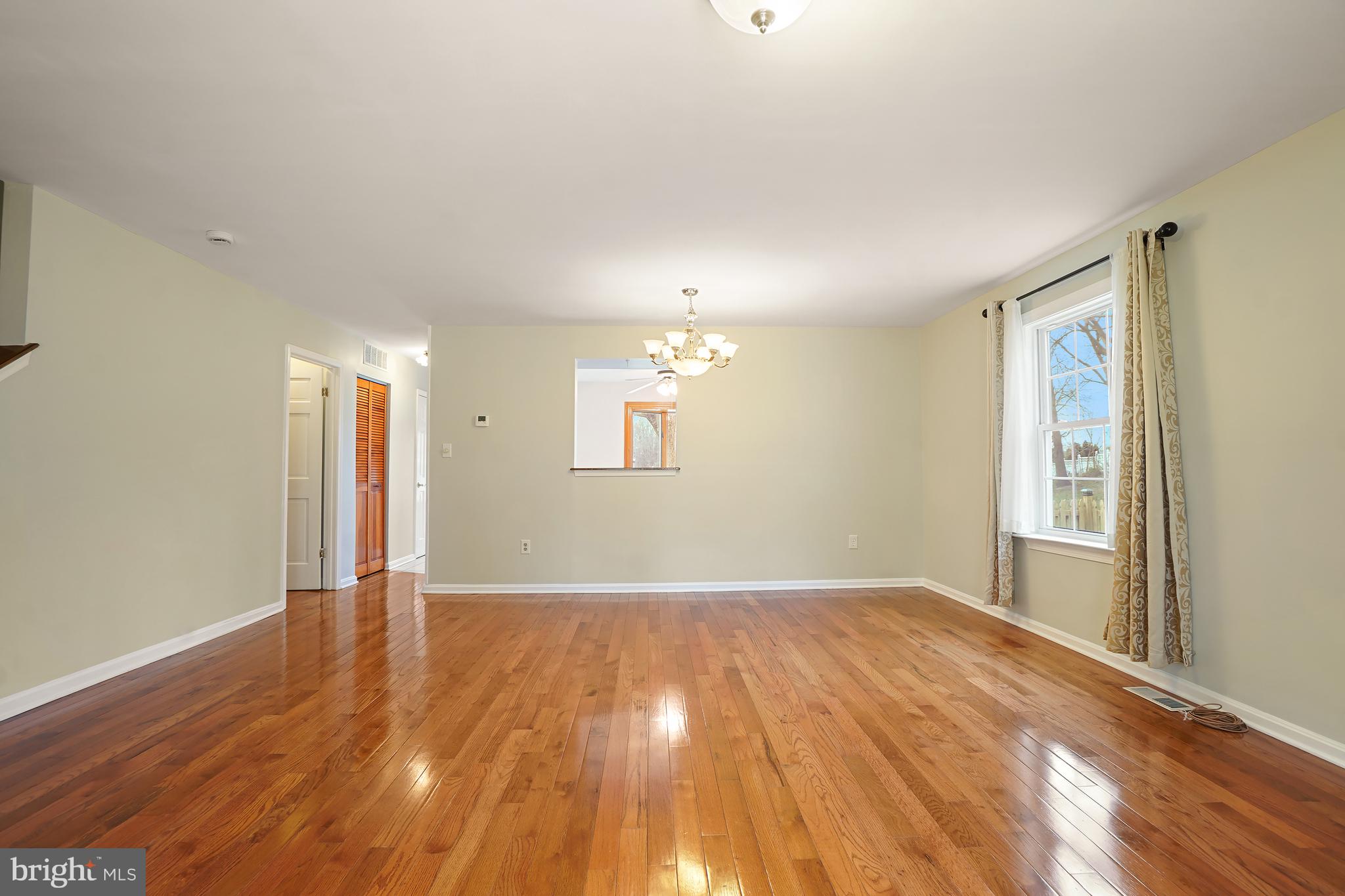 9412 Kilbride Court Perry Hall, MD 21128 - Photo 17 of 52 a view of an empty room with wooden floor and a window