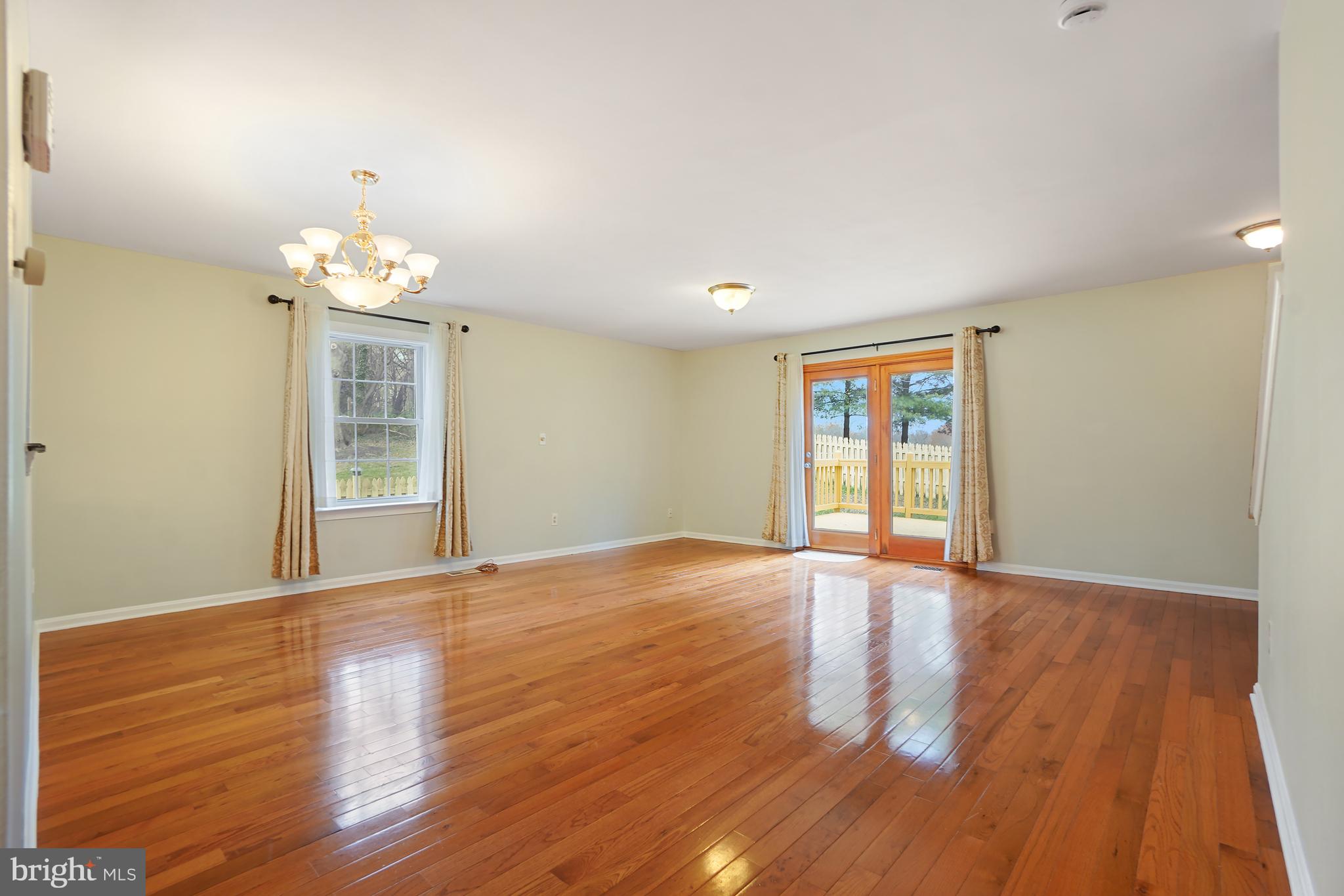 9412 Kilbride Court Perry Hall, MD 21128 - Photo 18 of 52 a view of an empty room with wooden floor and a window