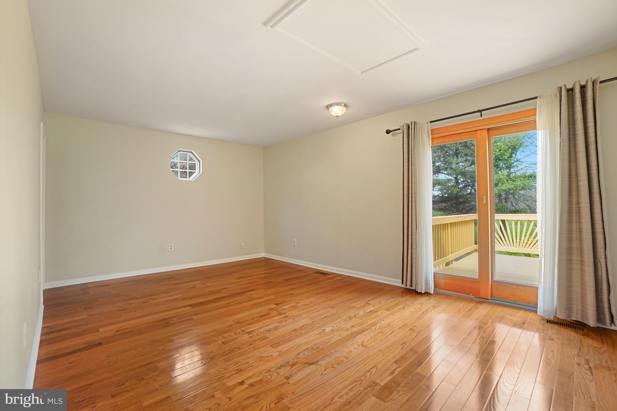 9412 Kilbride Court Perry Hall, MD 21128 - Photo 19 of 52 a view of an empty room with wooden floor and a window