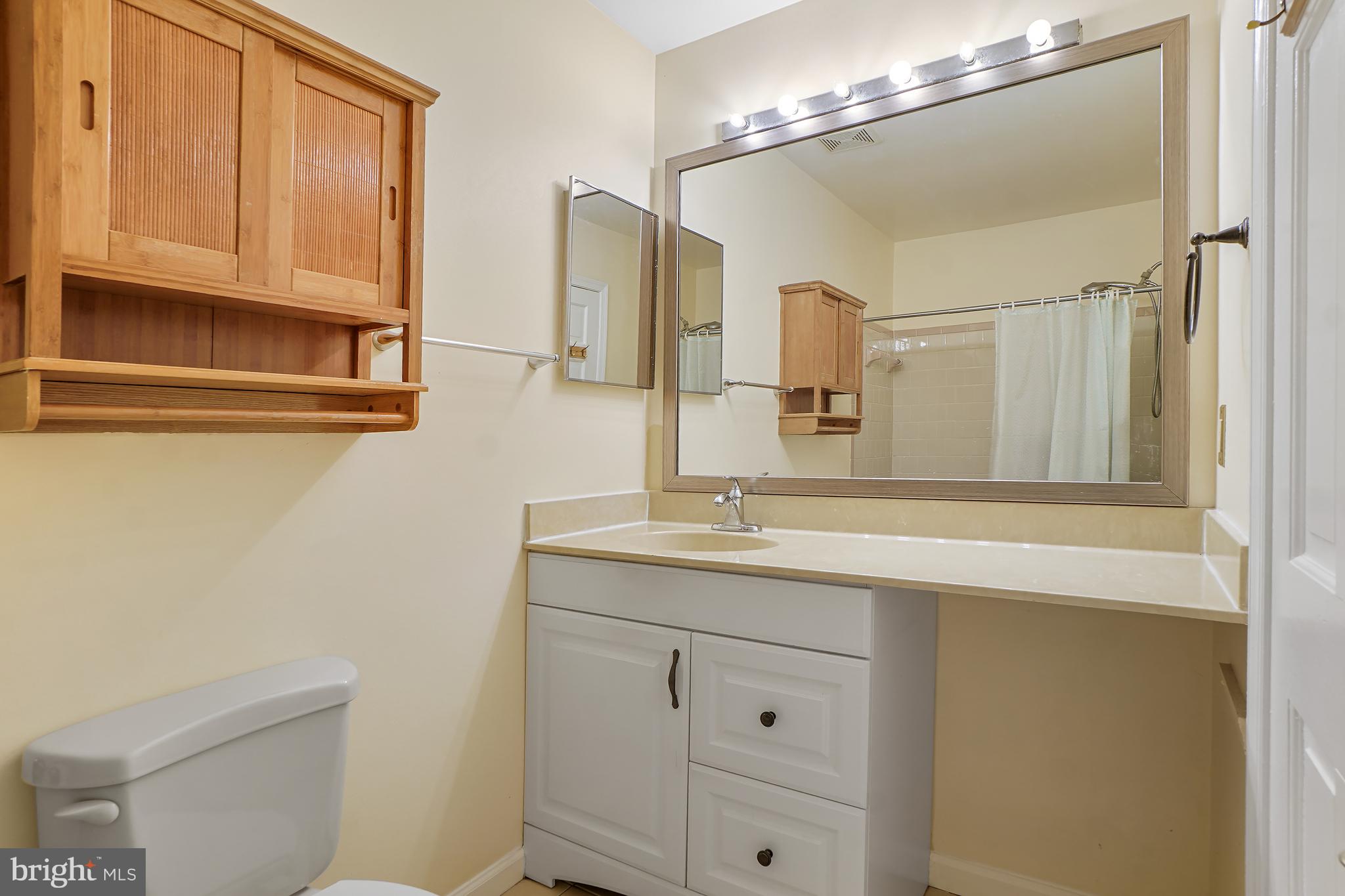 9412 Kilbride Court Perry Hall, MD 21128 - Photo 27 of 52 a bathroom with a granite countertop sink a toilet and mirror