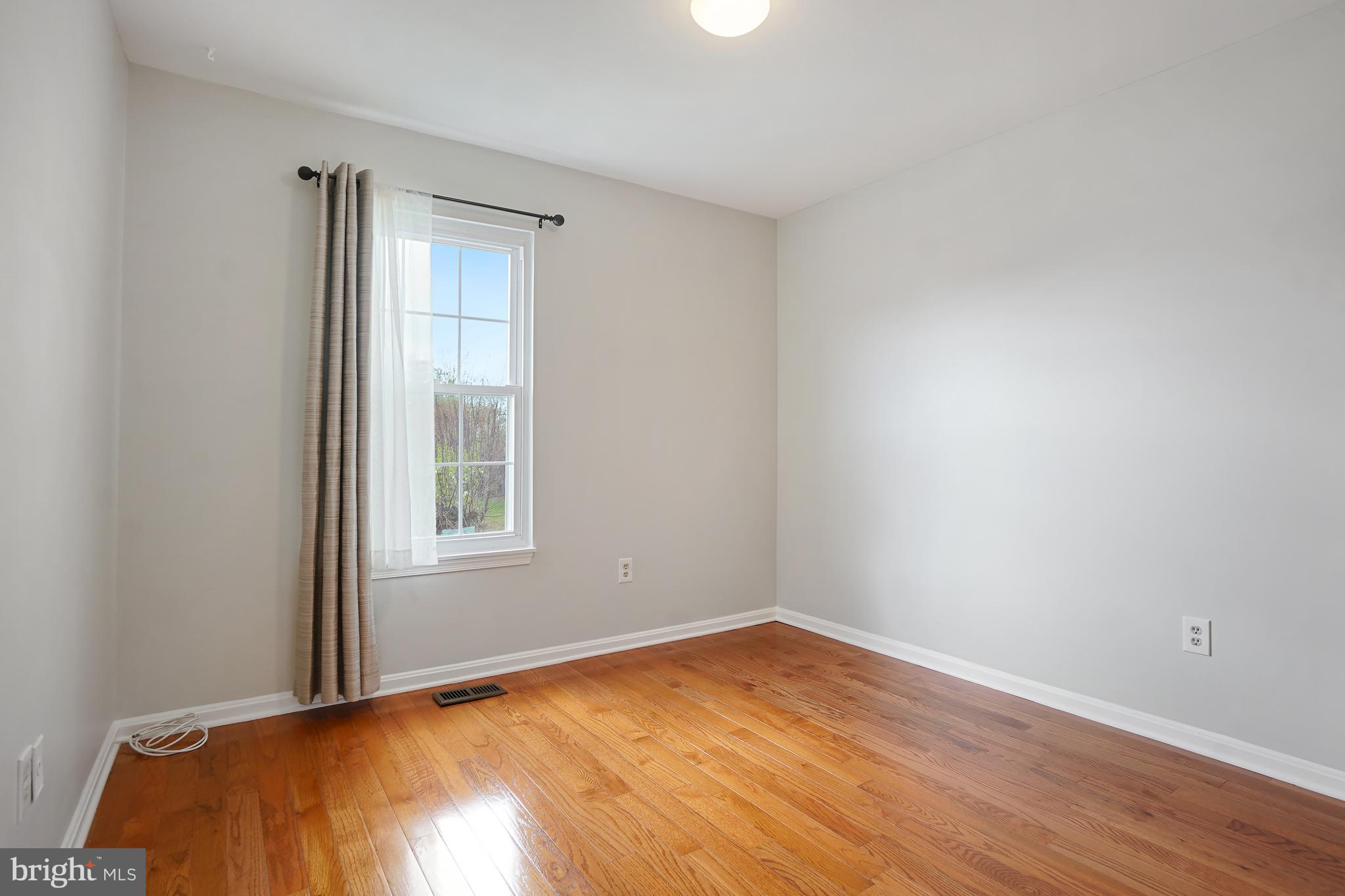 9412 Kilbride Court Perry Hall, MD 21128 - Photo 29 of 52 an empty room with wooden floor and windows