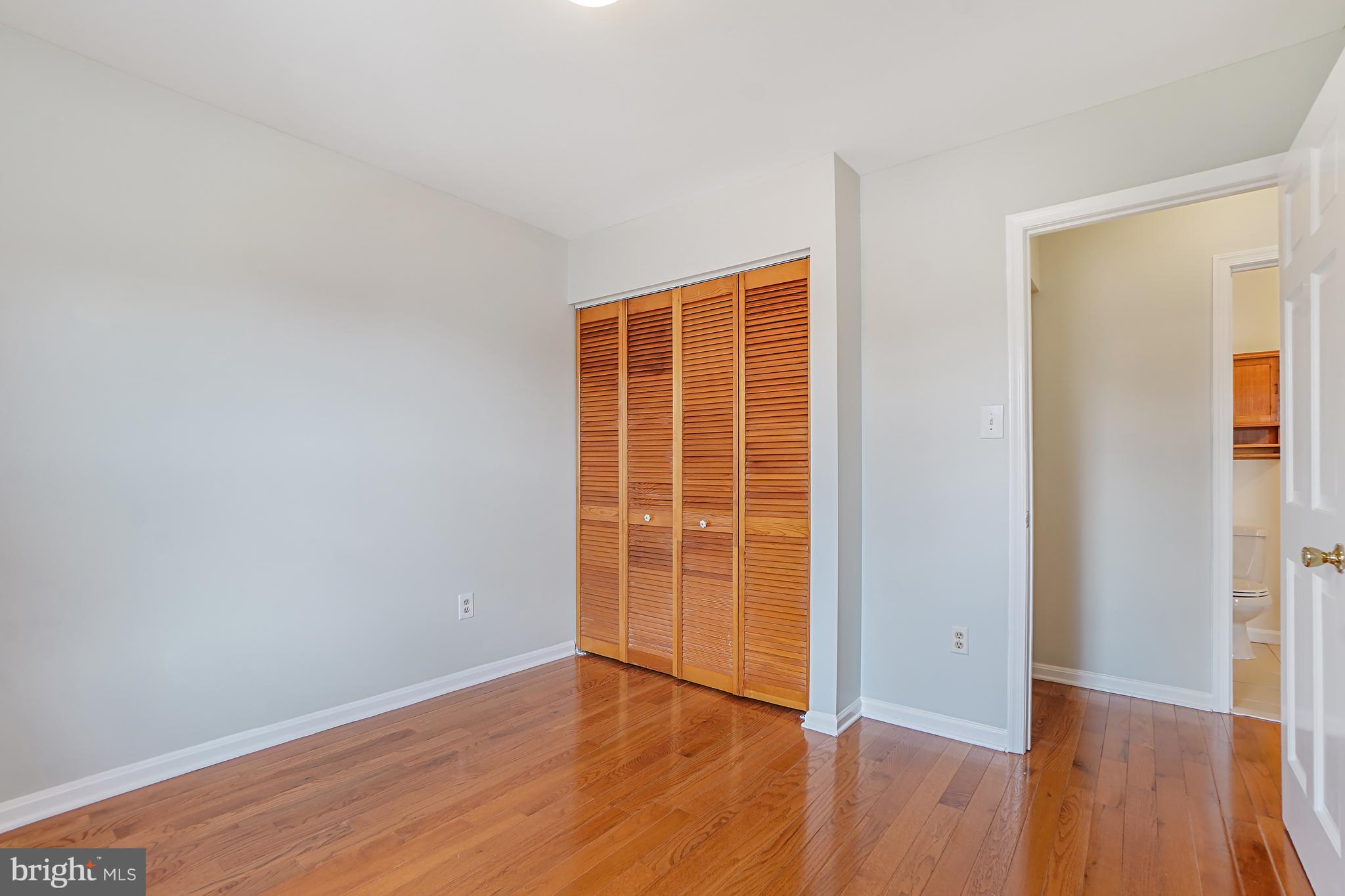 9412 Kilbride Court Perry Hall, MD 21128 - Photo 30 of 52 an empty room with wooden floor and windows