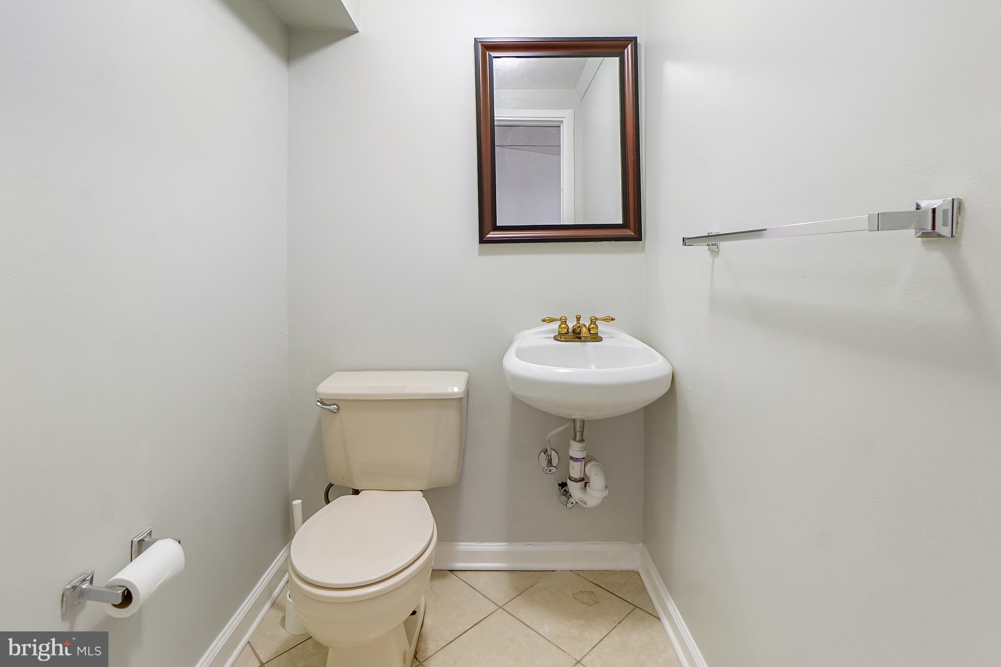 9412 Kilbride Court Perry Hall, MD 21128 - Photo 34 of 52 a bathroom with a sink toilet and a mirror