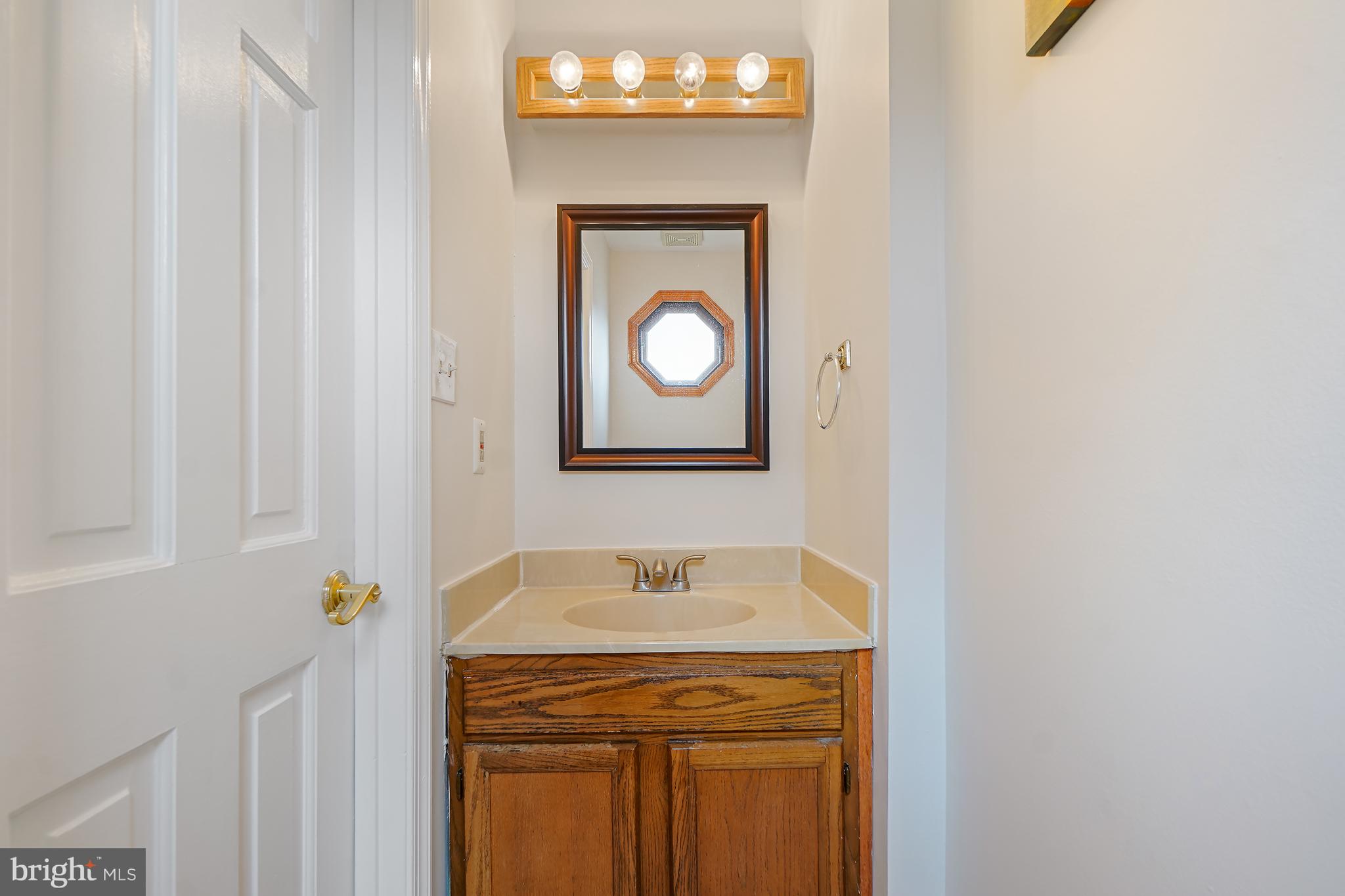 9412 Kilbride Court Perry Hall, MD 21128 - Photo 7 of 52 a bathroom with a sink and a mirror