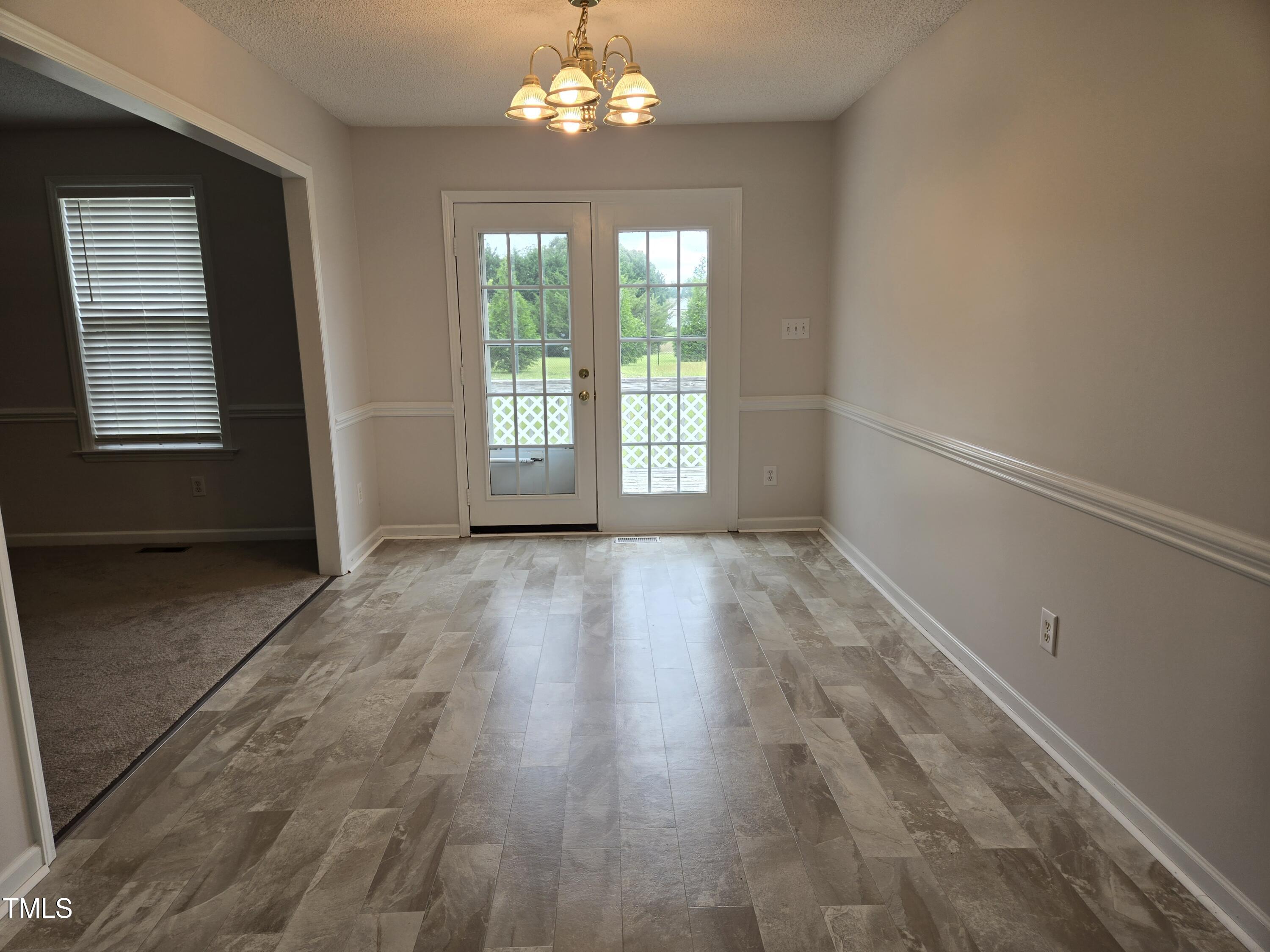 288 Rosa Circle Willow Spring, NC 27592 - Photo 6 of 19 an empty room with wooden floor and windows