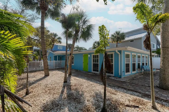a view of a house with a tree in front of it