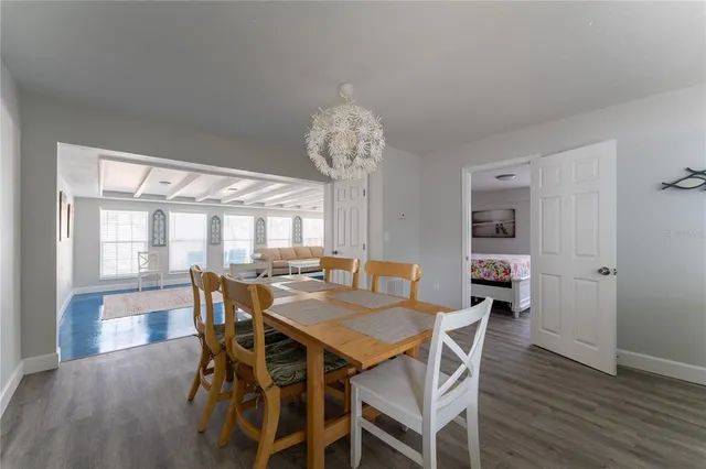 a view of a dining room with furniture wooden floor and chandelier