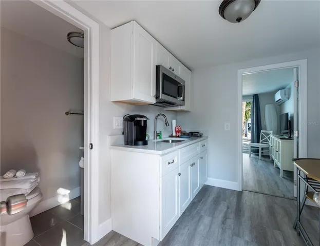 a kitchen with stainless steel appliances granite countertop a sink and cabinets