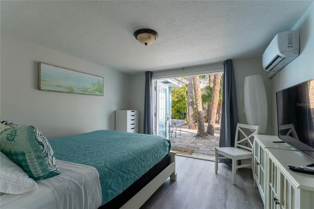 a bedroom with a bed and a flat screen tv