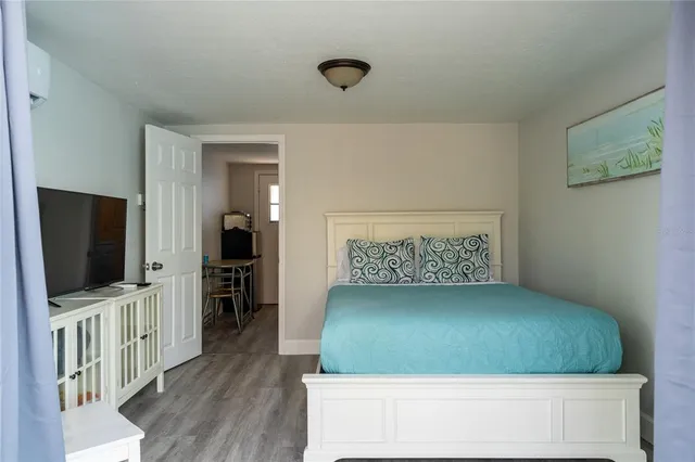 a living room with a flat screen tv and a refrigerator