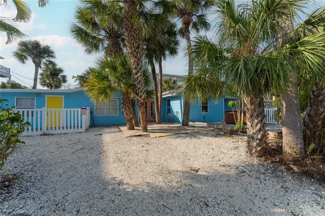 a view of a house with a yard and tree