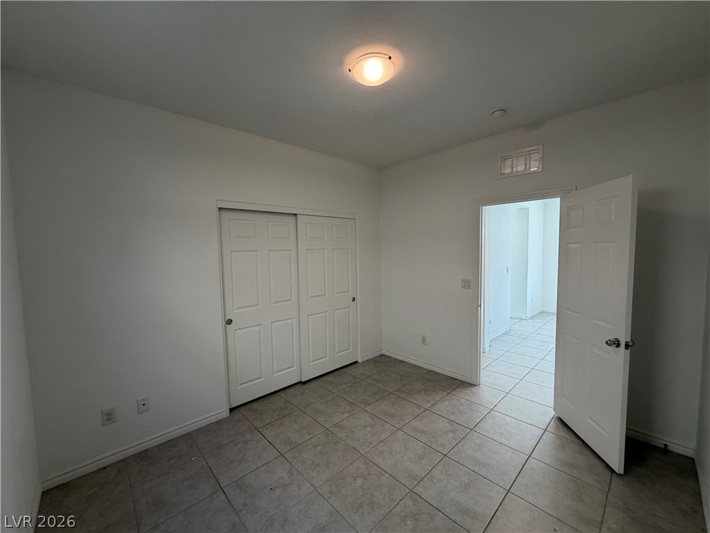 3228 Azalea Ridge Court Henderson, NV 89052 - Photo 20 of 28 An inviting room features a practical layout with durable tile flooring and convenient sliding closet doors.