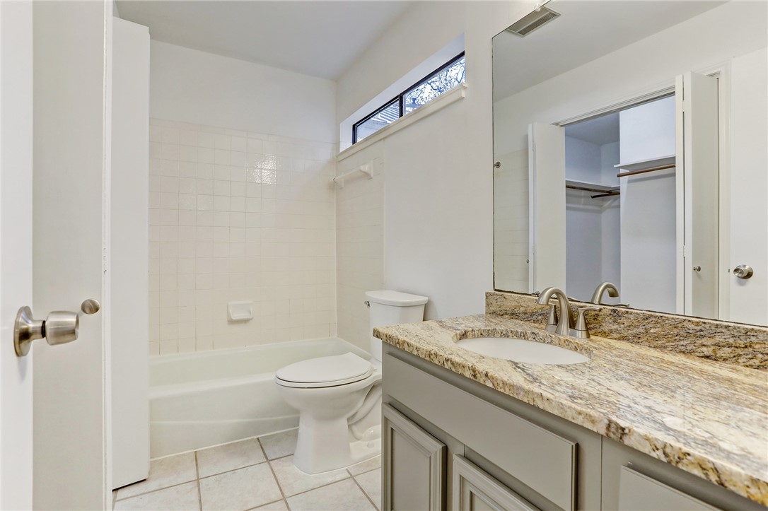 2507 Quarry Road, Unit D Austin, TX 78703 - Photo 6 of 9 a bathroom with a granite countertop sink a toilet and shower
