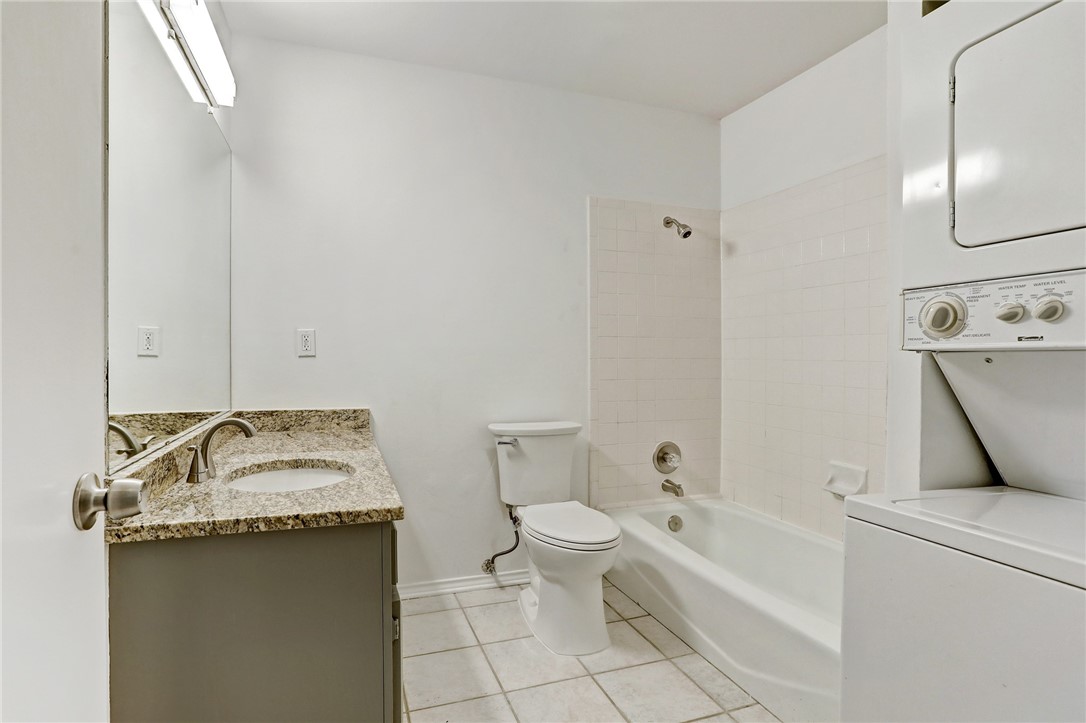 2507 Quarry Road, Unit D Austin, TX 78703 - Photo 8 of 9 a bathroom with a granite countertop sink a toilet and bathtub